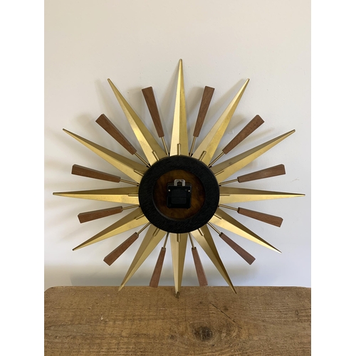 40 - A vintage West German made sunburst battery wall clock, 22 1/2