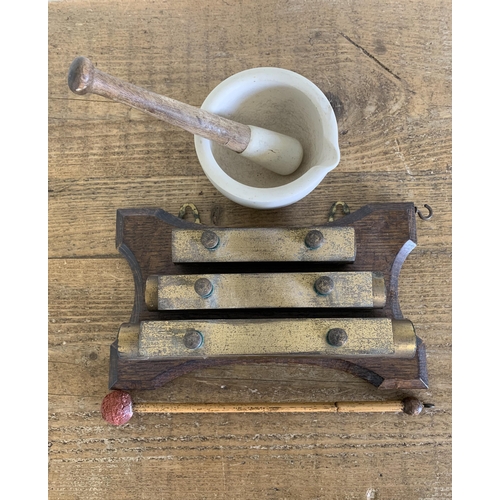 49 - An antique wall hanging glockenspiel plus a small pestle and mortar