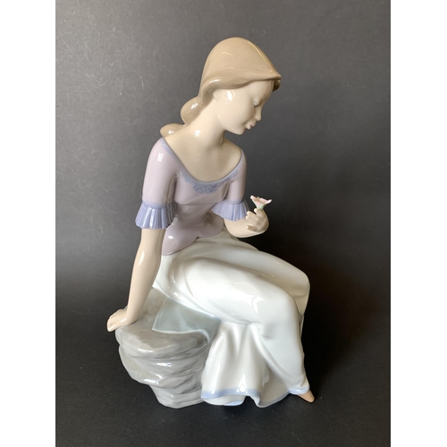 5 - A large Lladro Nao figurine, girl with flower, 11