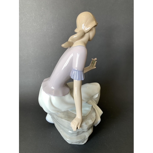 5 - A large Lladro Nao figurine, girl with flower, 11