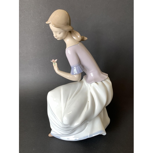 5 - A large Lladro Nao figurine, girl with flower, 11