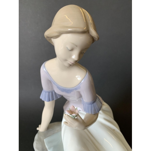 5 - A large Lladro Nao figurine, girl with flower, 11