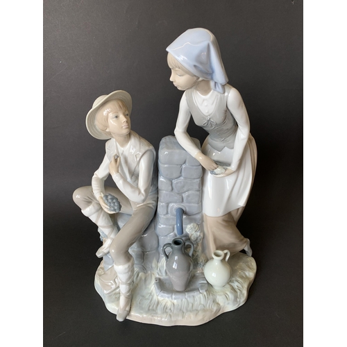 6 - A large Lladro Nao figurine, boy and girl at a well, 13