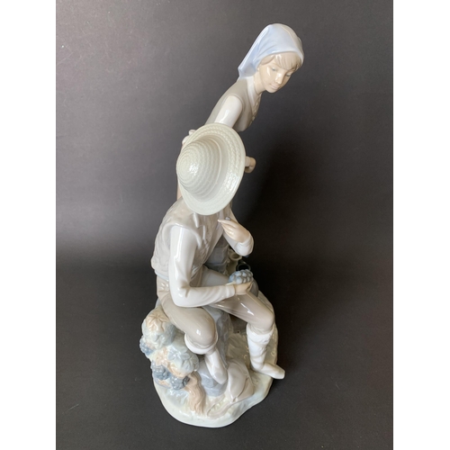 6 - A large Lladro Nao figurine, boy and girl at a well, 13