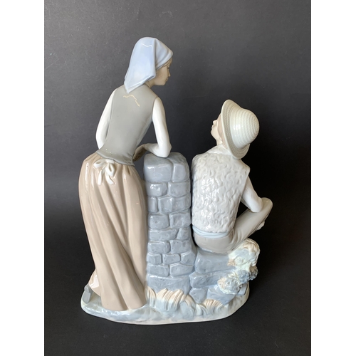 6 - A large Lladro Nao figurine, boy and girl at a well, 13