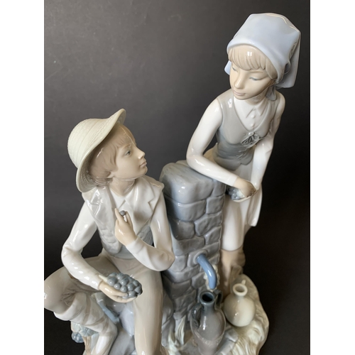 6 - A large Lladro Nao figurine, boy and girl at a well, 13