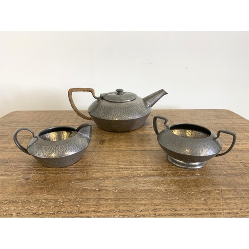 73 - A three piece Tudric pewter ware tea set