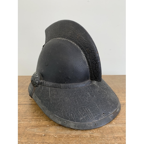 A late 19th Century Scottish leather fireman's helmet, marked on the ...