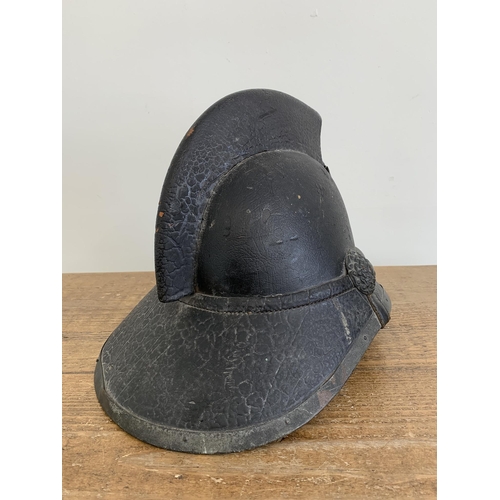 A late 19th Century Scottish leather fireman's helmet, marked on the ...