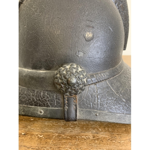 A late 19th Century Scottish leather fireman's helmet, marked on the ...