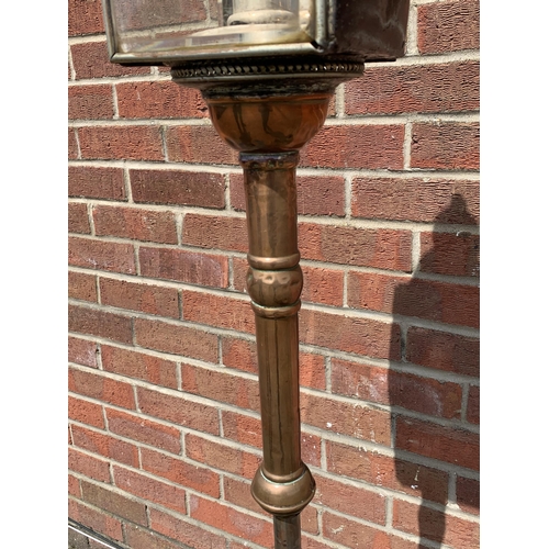 358 - An unusual vintage copper based standard lamp with carriage lamp style top, adjustable column and fo... 