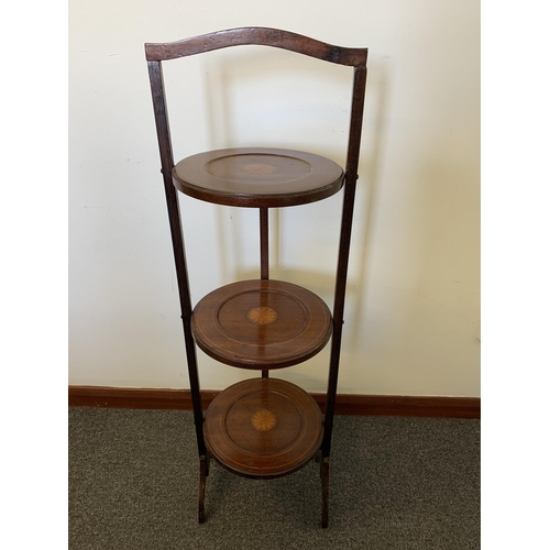 43 - An Edwardian inlaid wooden three shelf folding cake stand, 35