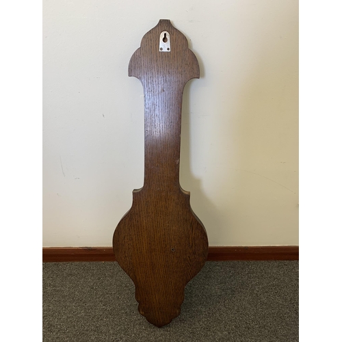 46 - A large oak cased aneroid barometer with thermometer, 32