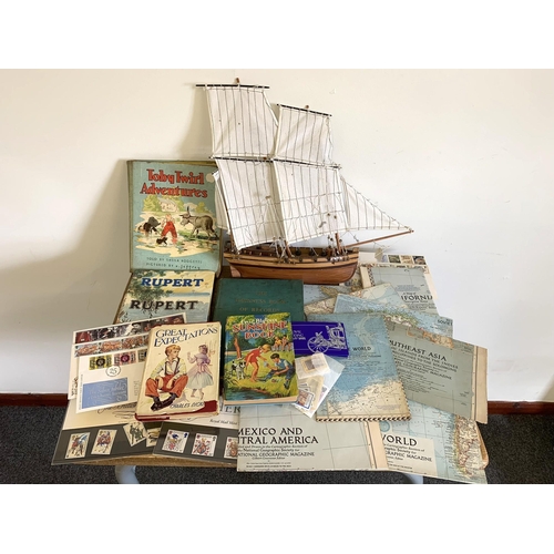 62 - A wooden model boat plus a selection of maps and books including 1955 3rd edition of the Guinness Bo... 