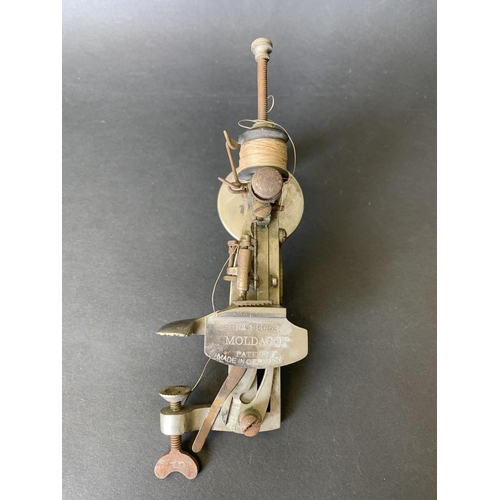An early 20th Century 'Moldacot' lockstitch pocket sewing machine