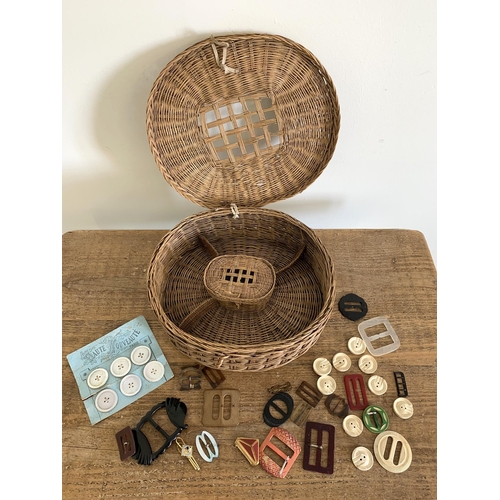 96 - A vintage wicker sewing basket plus a selection of vintage belt buckles and buttons