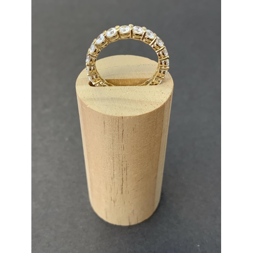 113 - A 14ct gold and cubic zirconia QVC eternity ring, approx. size R