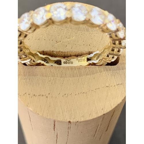 113 - A 14ct gold and cubic zirconia QVC eternity ring, approx. size R