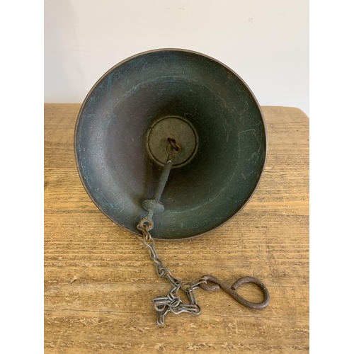 13 - A vintage brass bell with bracket and clapper plus a large brass urn and a solid heavy brass jug