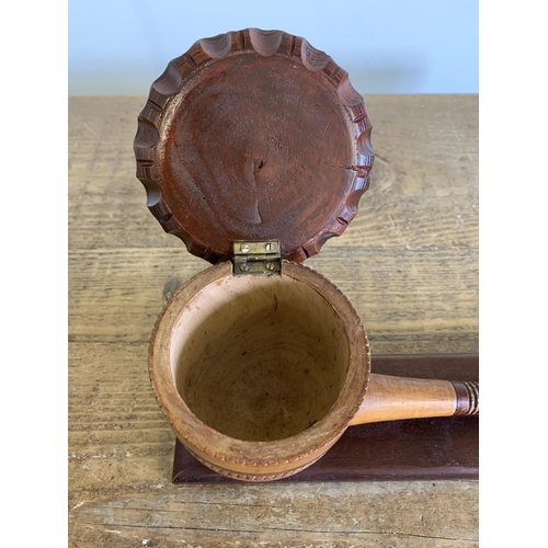 150 - A vintage very large ornamental wood pipe with hinged lid on wood stand, 10 1/4