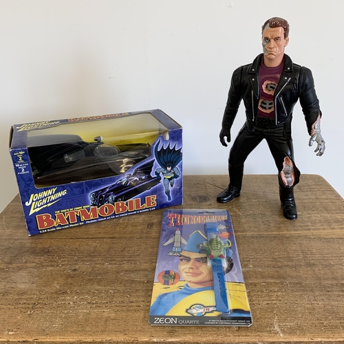 155 - A Johnny Lightning 1/24 scale Batmobile boxed together with a Terminator figure and a Thunderbirds w... 