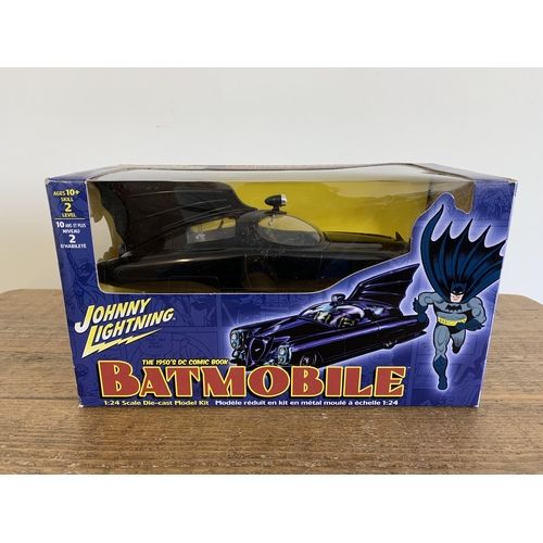 155 - A Johnny Lightning 1/24 scale Batmobile boxed together with a Terminator figure and a Thunderbirds w... 