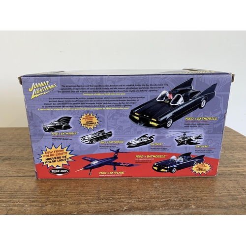 155 - A Johnny Lightning 1/24 scale Batmobile boxed together with a Terminator figure and a Thunderbirds w... 