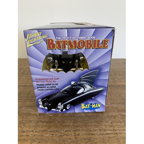 155 - A Johnny Lightning 1/24 scale Batmobile boxed together with a Terminator figure and a Thunderbirds w... 