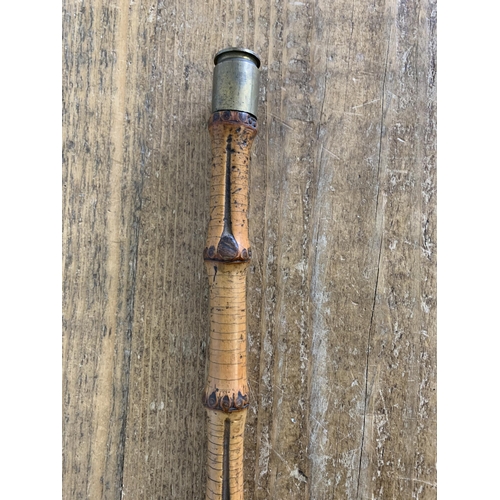 257 - A vintage bamboo type swagger stick with a used Nato shell on the tip, length 30