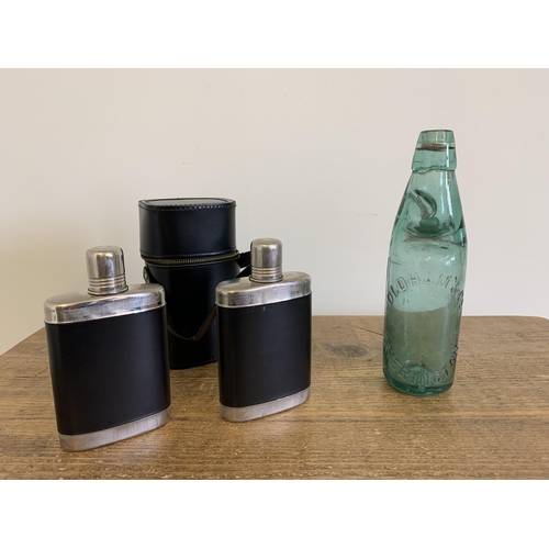 263 - A double white metal mount hip flask in leather holder plus a vintage Cods bottle