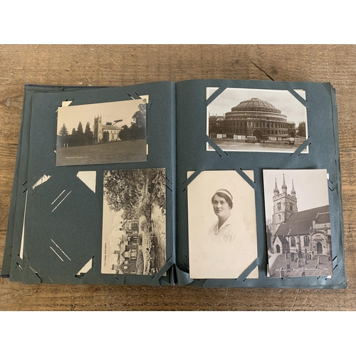 29 - A part filled vintage postcard album with postcards and photographs plus a second destressed album w... 