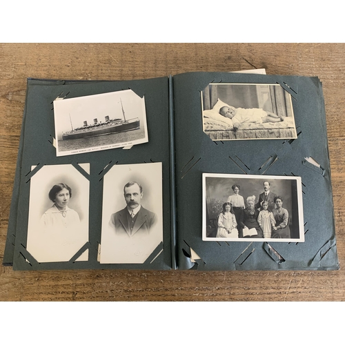 29 - A part filled vintage postcard album with postcards and photographs plus a second destressed album w... 