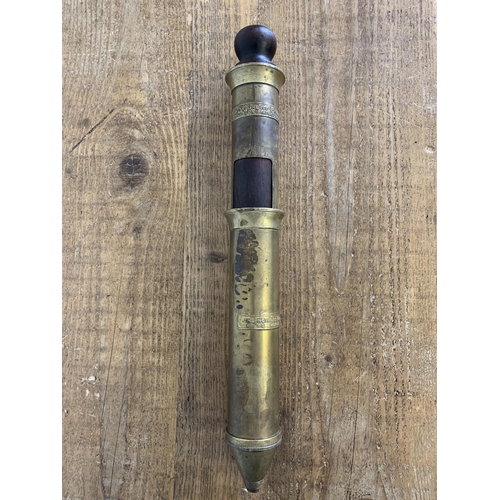 401 - An antique brass and hard wood plunger by Royal Grease