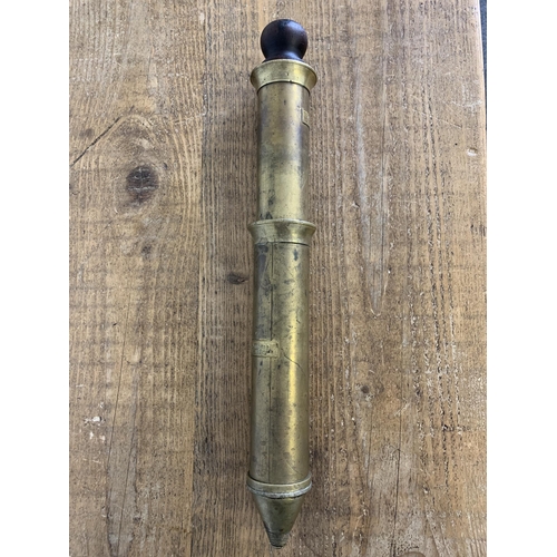 401 - An antique brass and hard wood plunger by Royal Grease