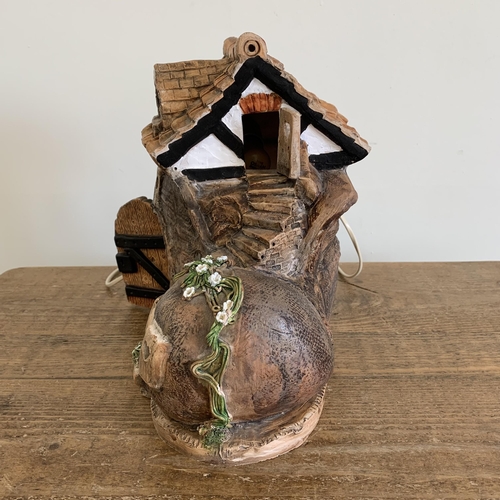 84 - David Taylor Pottery Norfolk, a ceramic boot shaped house wired as a table lamp with hedgehog attend... 