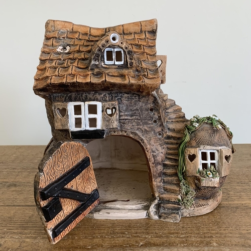 84 - David Taylor Pottery Norfolk, a ceramic boot shaped house wired as a table lamp with hedgehog attend... 