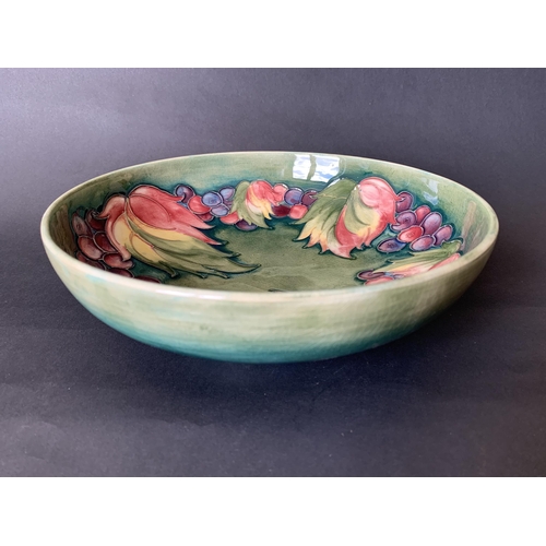 93 - A Moorcroft mid century berry and leaf pattern dish, blue signature to base, 8 1/2