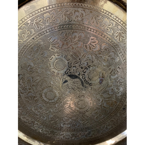 421 - Two Indian style brass trays, the largest 22 1/2