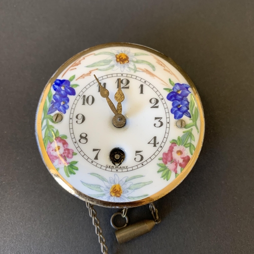 106 - A small hand painted porcelain clock with a hallmarked silver topped cane, 10