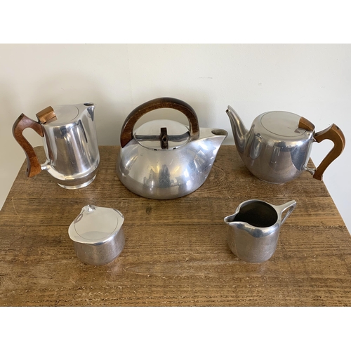 11 - A vintage Picquot ware three piece tea set together with a large kettle and teapot by 'New Maid' on ... 