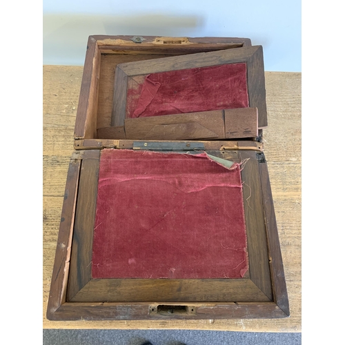 131 - A Victorian rosewood veneered writing slope (for restoration)