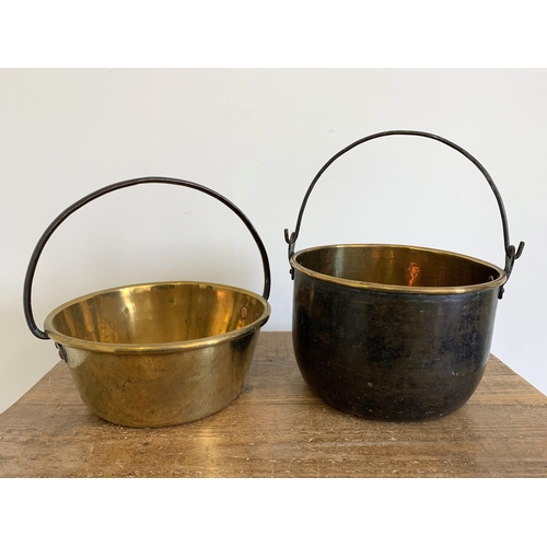 135 - A Victorian brass cauldron plus a brass jam pan, both with iron handles