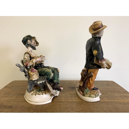 14 - A vintage Capodimonte porcelain tramp figure plus an Italian made porcelain newspaper seller