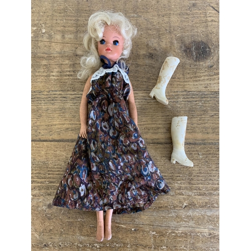 163 - A 1970's Sindy doll with period dress and boots