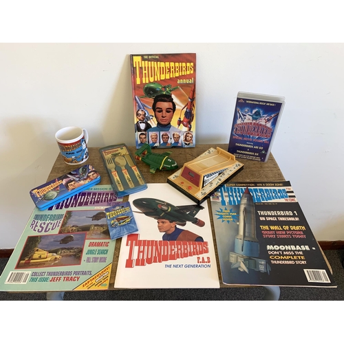 164 - A selection of vintage Thunderbirds related merchandise including a 1992 alarm clock, 1991 cutlery, ... 