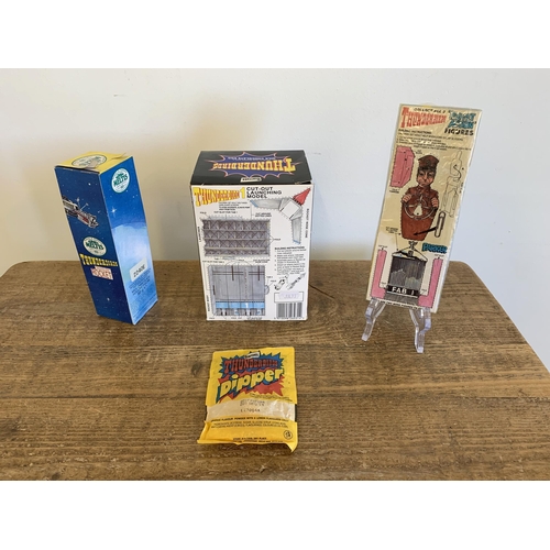 165 - A 1991 Barratt Thunderbirds chocolate Easter egg, a 1992 Meltis chocolate rocket, packaged Lyons 199... 