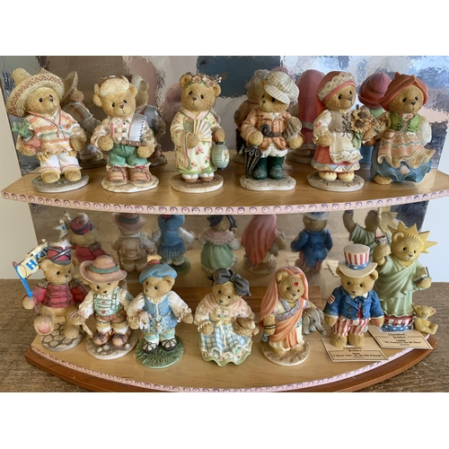 170 - A Cherished Teddies by 'Evesco' display stand with a selection of 13 World Edition bears