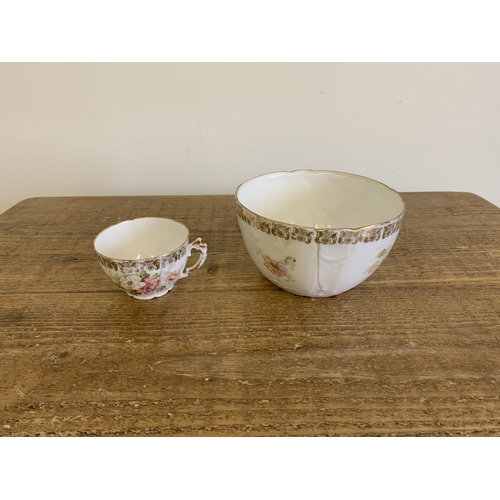 20 - An early 20th Century porcelain tea set with pink floral decoration (one cup and slop bowl with crac... 