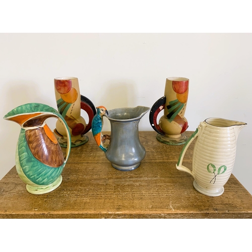 210 - A pair of Art Deco period 'Wardwick' ware jugs (some loss to paint) plus a Burleigh ware parrot jug ... 