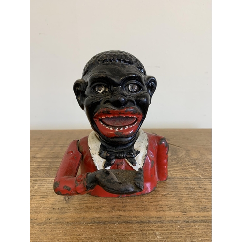 232 - A cast iron hand painted money box with moving eyes, 6